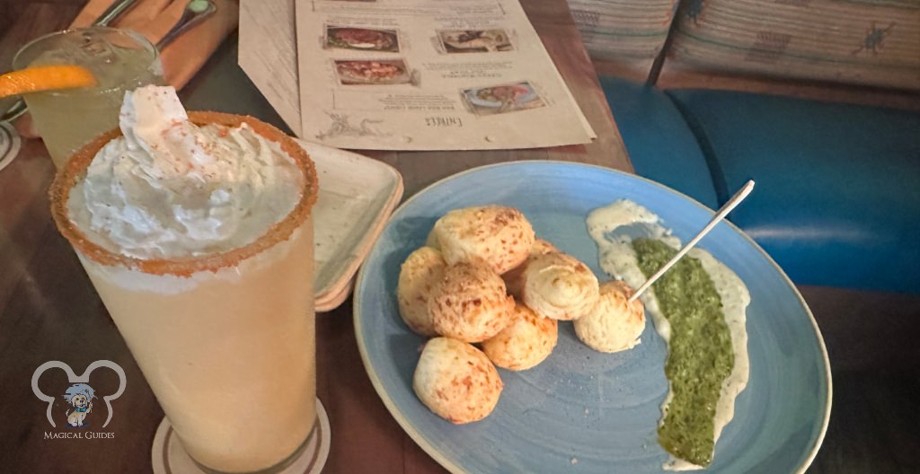 Magic Kingdom's Skipper Canteen featuring their Enchanted Dole Whip with an orange candy outer rim and "Secret Menu Item" Pao de Queijo Appetizer. 