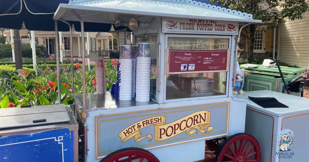 Popcorn cart in Magic Kingdom with standard popcorn buckets for sale.