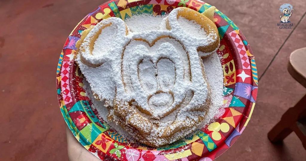 Powdered sugar covers huge mickey waffle.