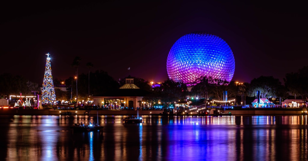 View of Christmas tree and Spaceship Earth across the World Showcase at EPCOT