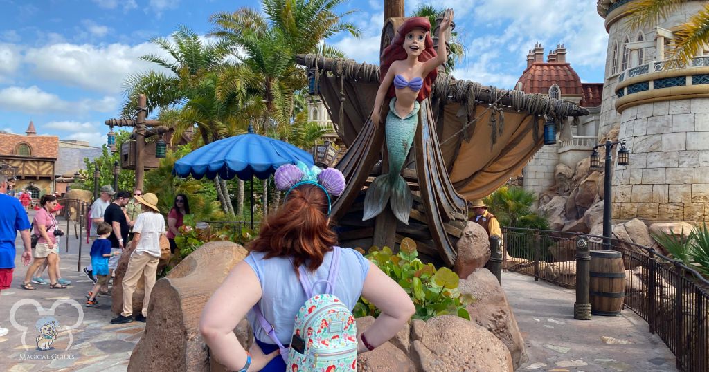 Standing outside the Little Mermaid ride dressed in an Ariel Disney Bounding, complete with ears and Little Mermaid Loungefly.