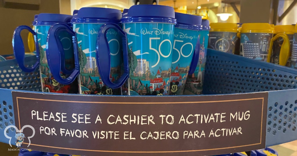 Disney refillable mugs sitting on a rack in the middle of the food court at Disney's Port Orleans Riverside.