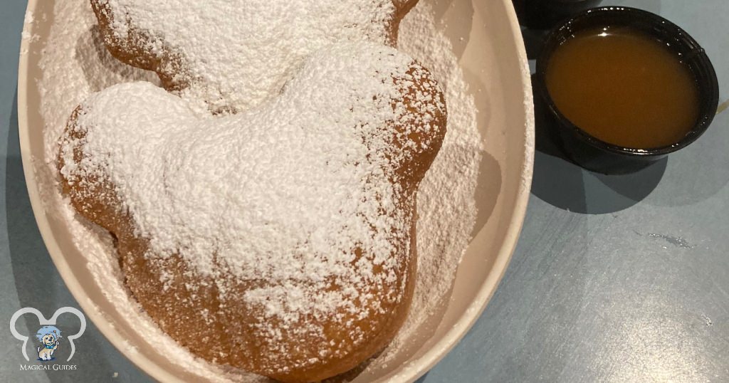 Hot and fresh beignets at the Port Orleans French Quarter resort with caramel sauce.