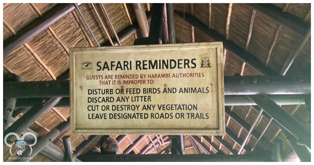 Kilimanjaro Safari Reminders Sign with rules for guests to follow in Animal Kingdom. Guests are reminded by Harambe authorities that it is improper to: Disturb or feed birds and animals. Discard any litter. Cut or destroy any vegetation. Leave designated roads or trails.