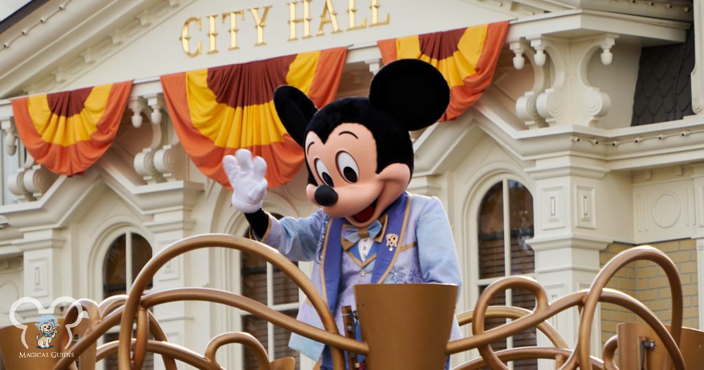 Mickey Mouse waving to all the park goers in front of City Hall in Magic Kingdom.