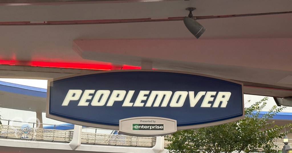 The PeopleMover sign in Magic Kingdom. Look for this sign to find the attraction's entrance.