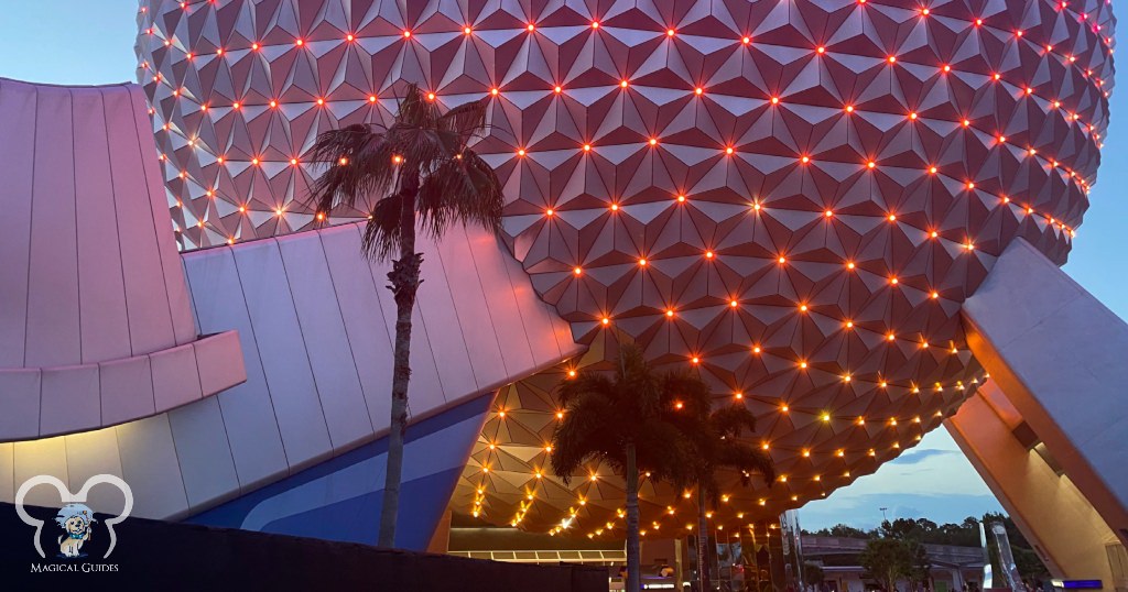 The underside of the EPCOT dome with the lights coming on shows the support beams of the massive structure.