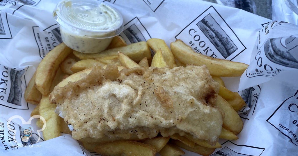 Fish & Chips from Cooke's of Dublin, a quick service location in Disney Springs. This fried fish is served with french fries and tartar sauce.