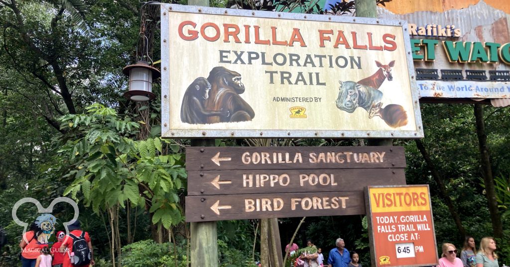 Gorilla Falls Exploration Trail sign including Gorilla Sanctuary, Hippo Pool, and Bird Forest.