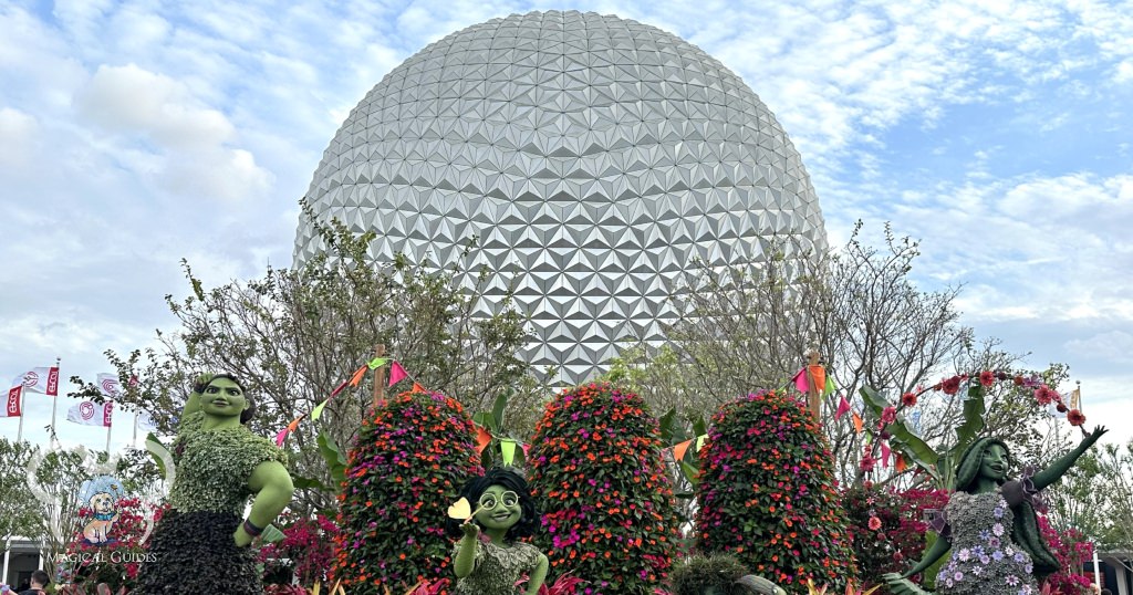 EPCOT Ball or the official name, Spaceship Earth behind the Encanto Topiaries at the 2023 EPCOT Flower & Garden Festival.