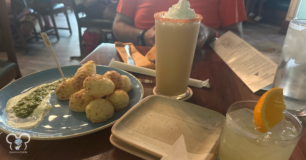 Secret menu item Pão de Queijo (Brazilian Bread), Enchanted Orange Dream, and a Golden Haze Margarita. All three are delicious, but you will want to try the Pão de Queijo!