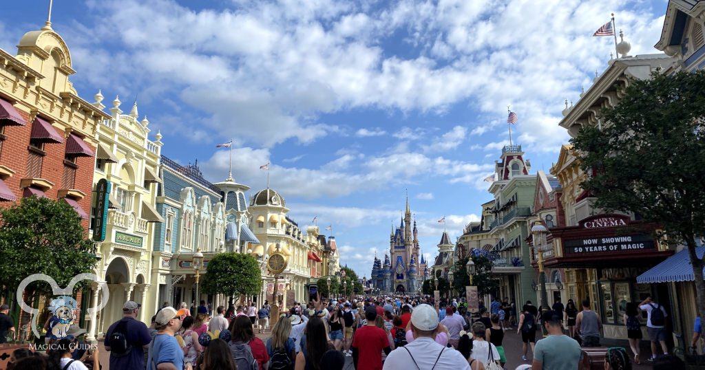 Magic Kingdom crowds walking down Main Street U.S.A. toward Cinderella's Castle at Early Entry and Rope Drop.