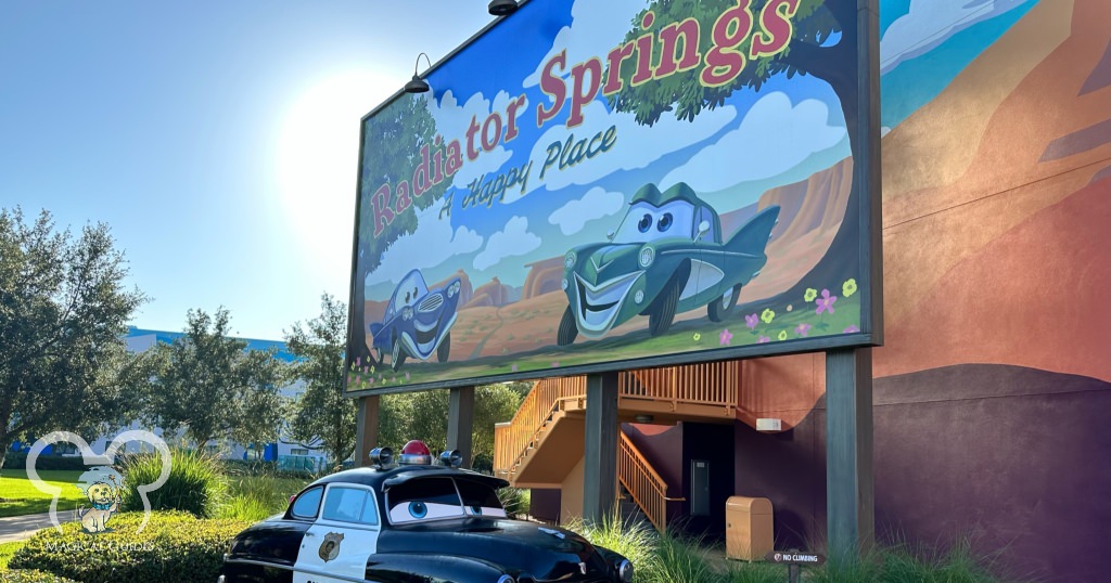 Radiator Springs Sign and police car in the Cars section of Art of Animation.