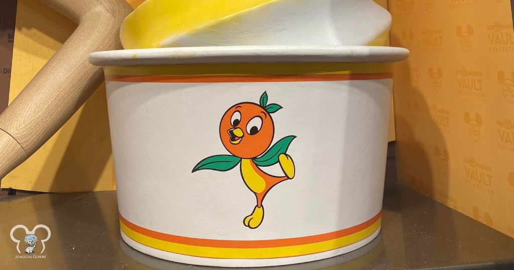 Orange Bird in a joyful pose, showing off his green leaves as wings and orange with a small beak.
