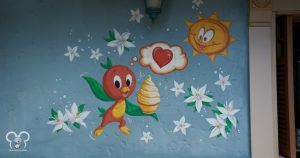 Orange bird holding a swirl with a heart at Sunshine Tree Terrace in Magic Kingdom