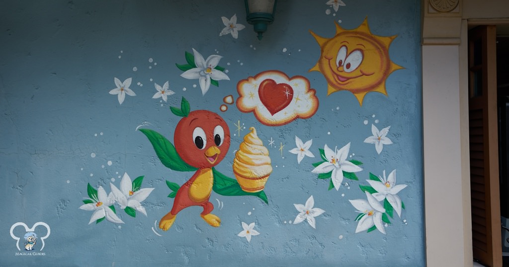 Orange bird holding a swirl with a heart at Sunshine Tree Terrace in Magic Kingdom