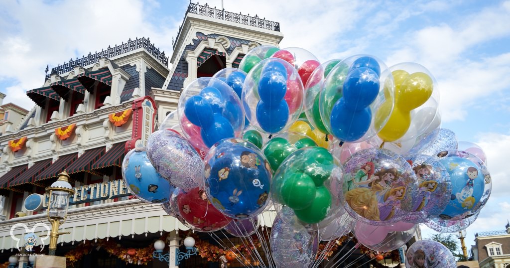 Balloons float on busy street near the Confectionary on Main Street USA in Magic Kingdom.