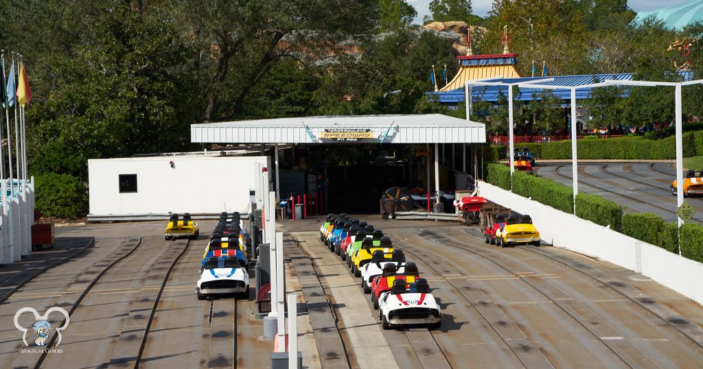 Many empty race cars in the repair shop waiting to go out into the loading area for guests.