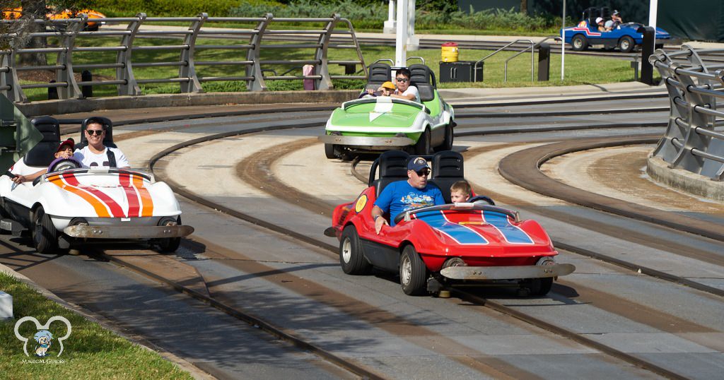 Kids driving a Tomorrowland Speedway car. There is a height requirement for this ride