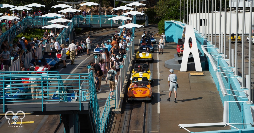 You can see the long line of guests waiting in the sun with umbrellas to shield you from the sun as you await your race car.